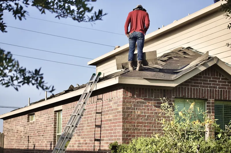 Professional roofer working on a residential roof in Tysons West